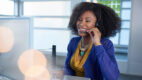 An african american woman assisting someone over the phone