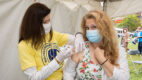 An Albany Med volunteer gives a fellow employee their flu shot at the annual Albany Med Employee picnic