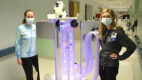 Two nurse standing next to a new mobile unit designed to help soothe and distract pediatric patients with sensory processing disorders, like Autism