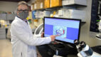 Antonio Paul, PhD, pointing at results on a computer monitor