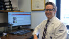 Evan Boyle, DO, sitting at his office desk