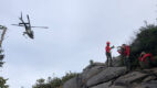 Hikers await a helicopter to medivac someone off of Algonquin Mountain