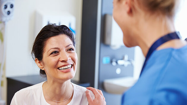 A nurse talking with, and comforting, a woman patient represents how the Patient & Family Advisory Council at Glens Falls Hospital works with patients, families and others to develop safe and effective hospital programs and services.