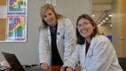 Drs. Jennifer Lindstrom and Danielle Wales pose at a table