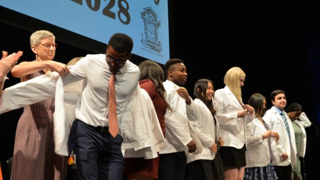 Medical students don their white coats for the first time at the Class of 2028 White Coat Ceremony