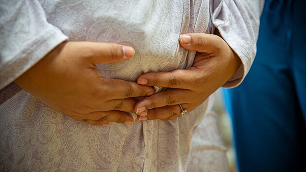 woman holding her pregnant belly