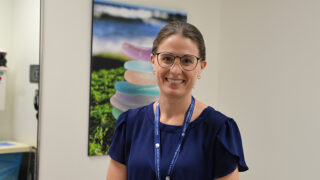 Urologist Dr. Jill Egan Kelly standing in an exam room