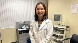 Dr. Tam Ramsey standing in a doctor's office