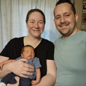 Mom and dad holding a baby