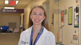 Endocrine surgeon Dr. Jessica Thiesmeyer standing in the surgery clinic hallway