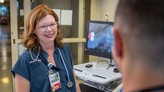 Clinician working at a mobile computer in the hospital.