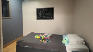 Room in The Cove set up for a patient with toys on the bed