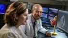 Two doctors looking at images on a computer screen