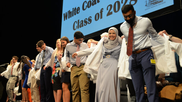 Medical students don their white coats for the first time at the Class of 2028 White Coat Ceremony