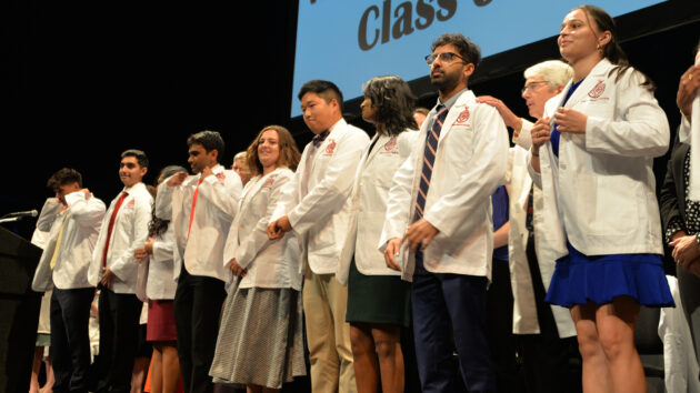 Medical students don their white coats for the first time at the Class of 2028 White Coat Ceremony