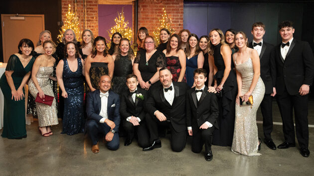 The Melodies Team and a patient's family posing for a group picture at Dancing in the Woods