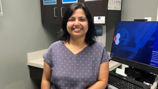 Dr. Aparajita Chaudhuri standing in a patient room