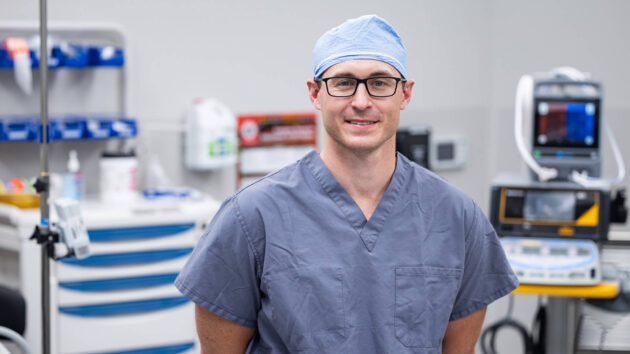 Surgical team member in operating room.