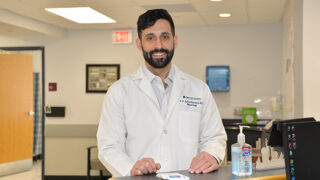 Dr. Emmanuel A. Aydin-Ghormoz standing in the nephrology clinic